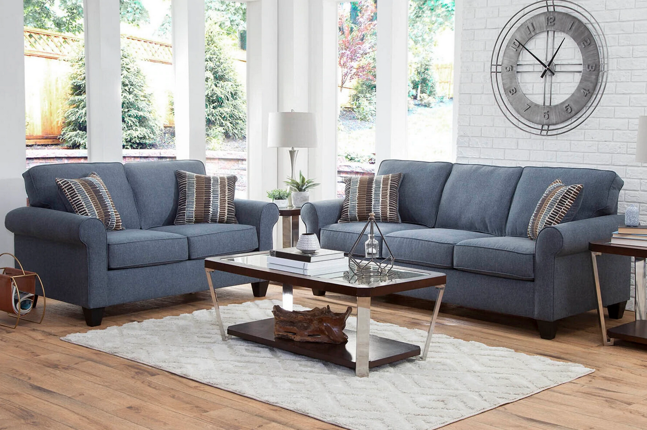 living room with blue sofa and glass coffee table