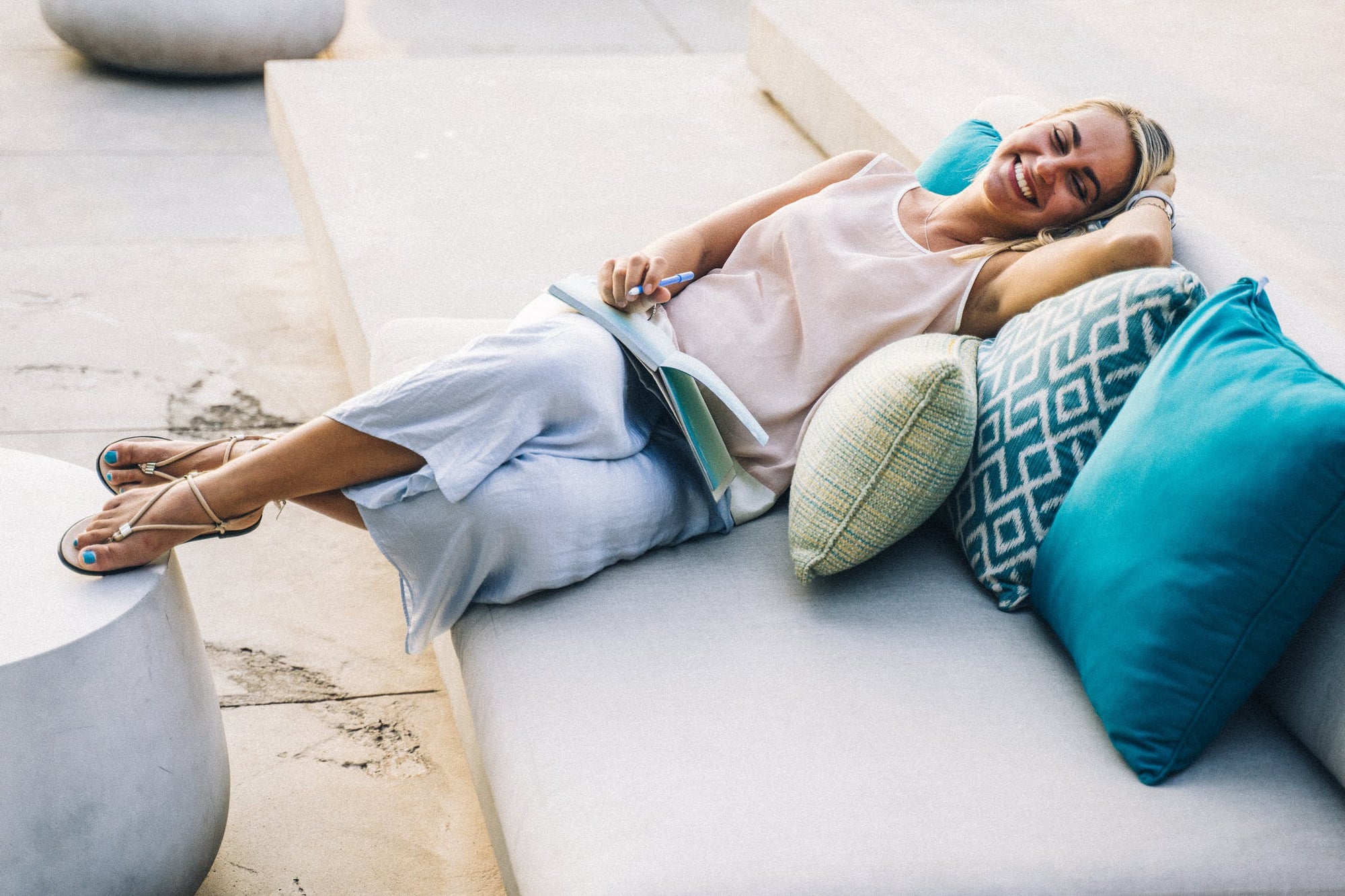 woman smiling on couch at vacation rental