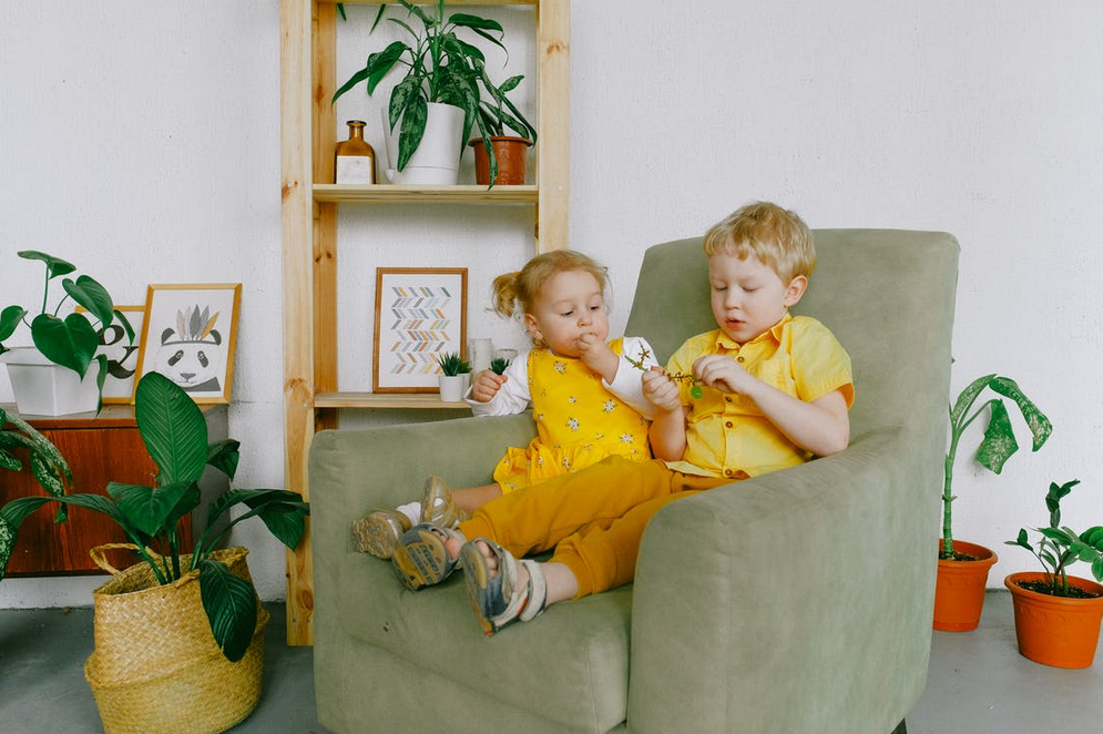 boy and girl in living room chair