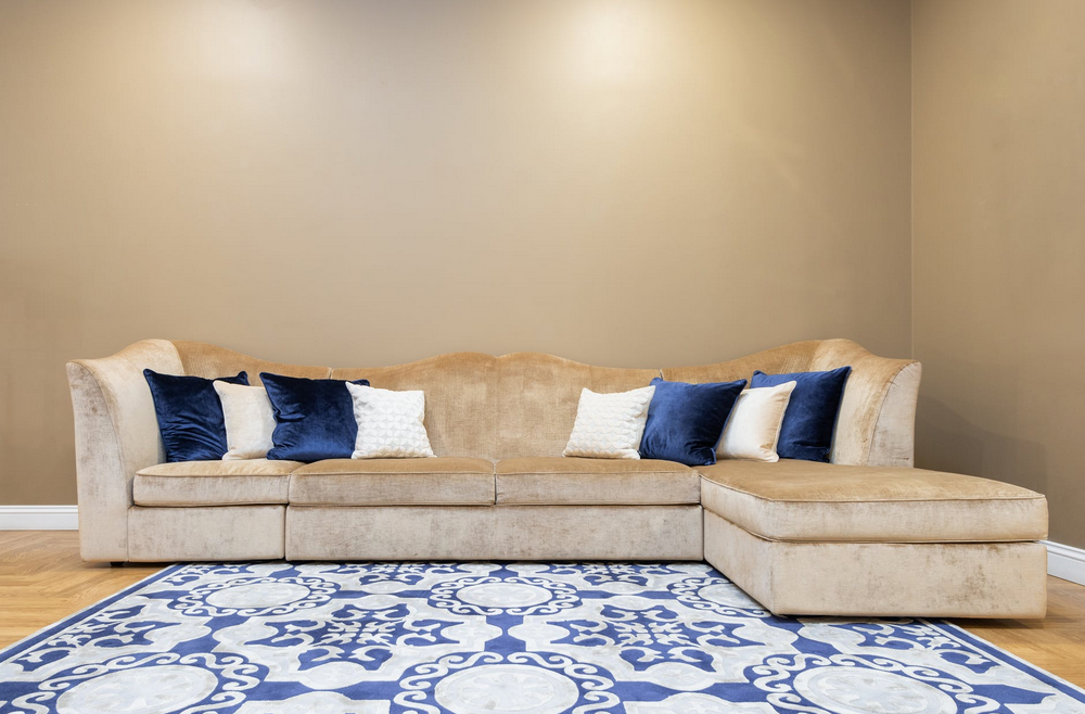 tan suede couch with blue pillows