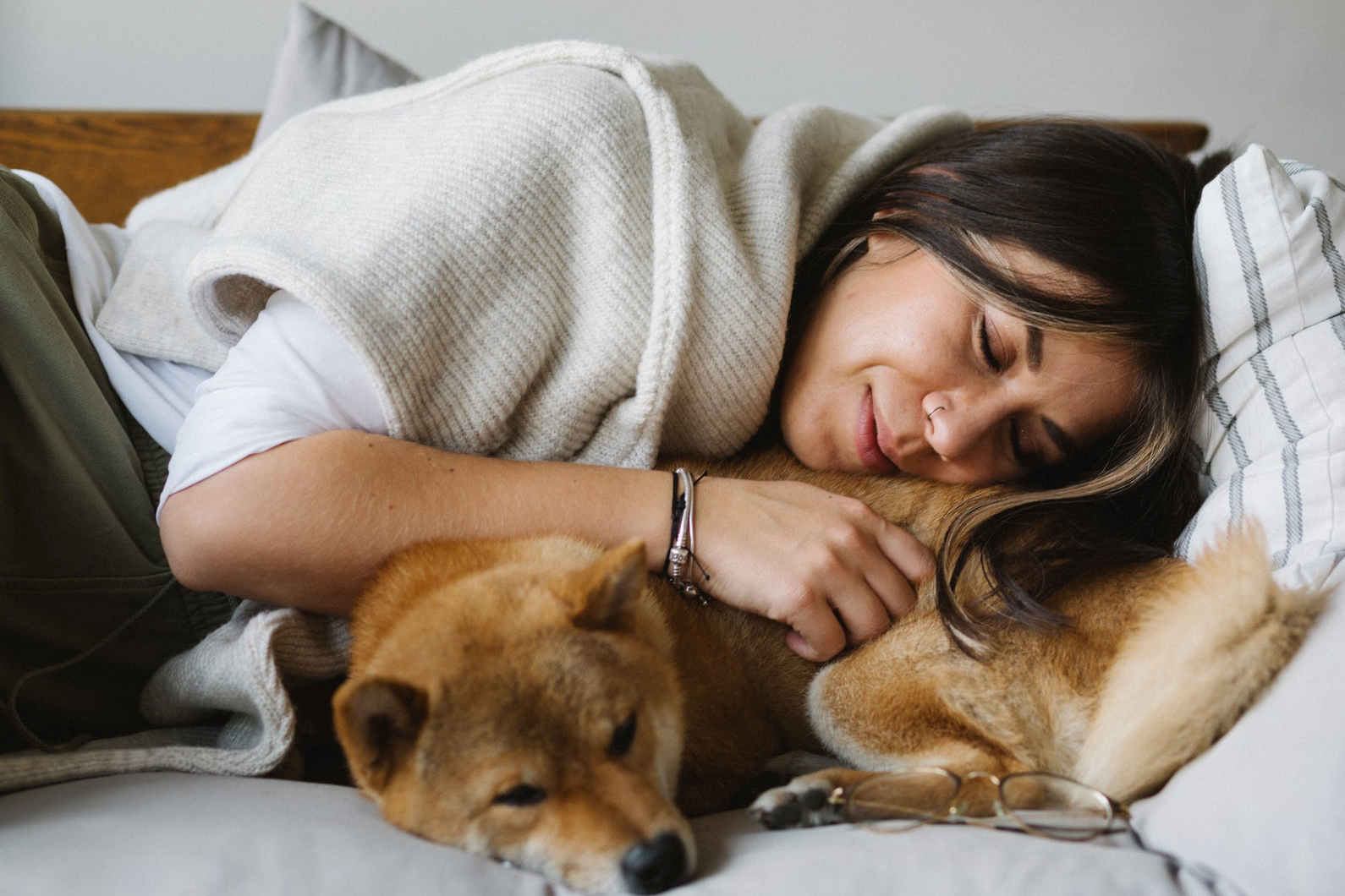 woman sleeping on couch with dog